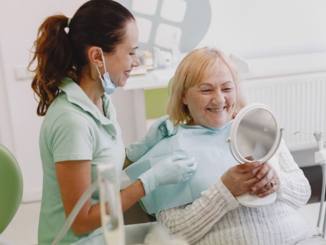 Dentist speaking with a patient during a consultation.